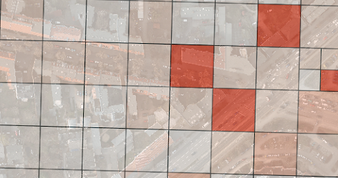 grid of squares overlayed over an aerial image with some areas of the grid darkened after tasks have been assigned a priority score.