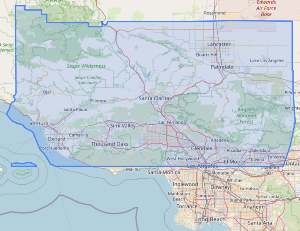 A shaded area with a blue outline overlayed over part of California including Santa Clarita and San Fernando. The shaded area is an irregular polygon that looks like a distorted rectangle. 