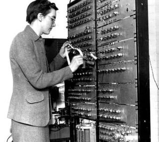 Kathleen Booth is shown next to a compiler. 
